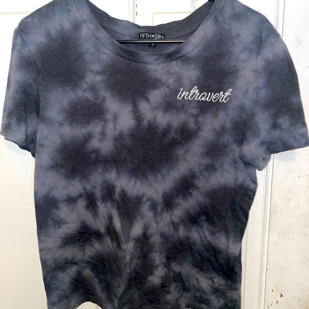 It is a crop top that says introvert on it